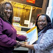 Leah Germany shaking hands with a client after a closing signing